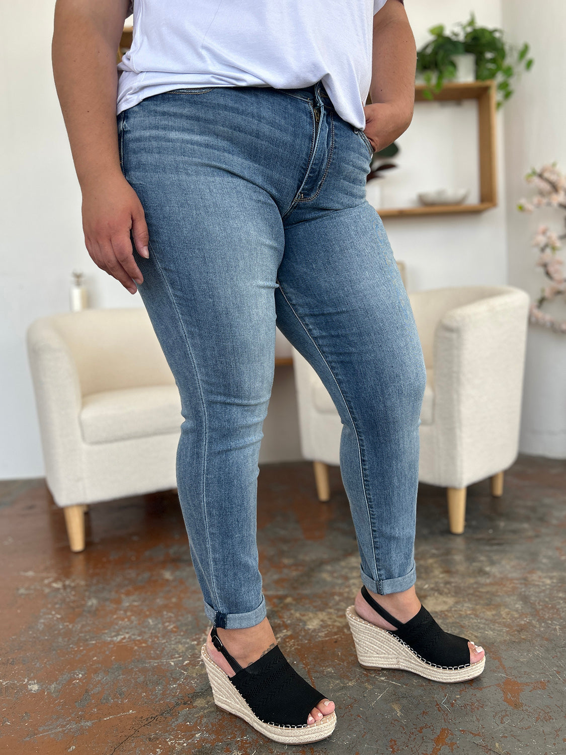 Trendsi plus size cuffed hem jeans styled with black wedge sandals in a casual indoor setting