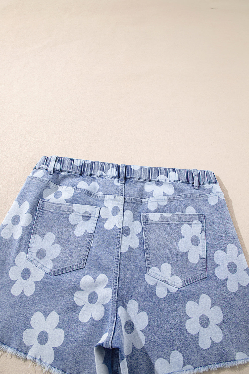 Plus size floral denim shorts with elastic waistband and large white flower print by kjplussizefashion