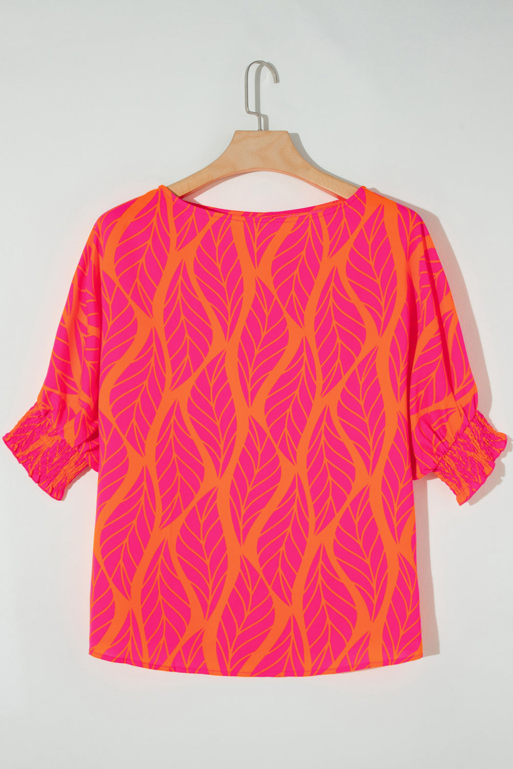 Plus size rose print blouse in vibrant pink and orange with leaf pattern and ruched sleeves