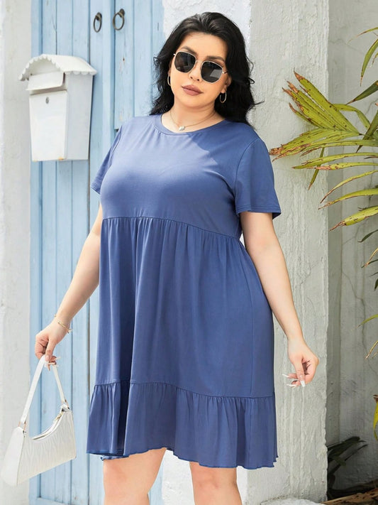 Trendsi plus size round neck dress in blue with short sleeves and ruffle hem worn with sunglasses