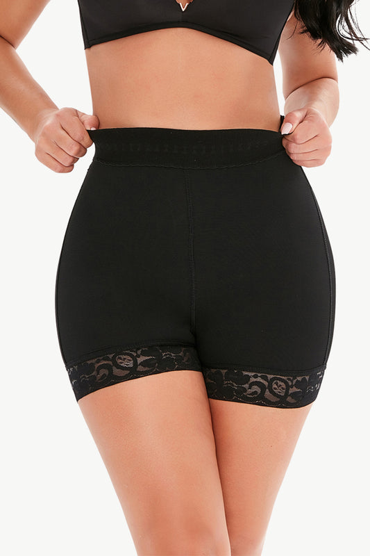 Trendsi plus size shaping shorts in black with lace trim worn by model showcasing high waist design