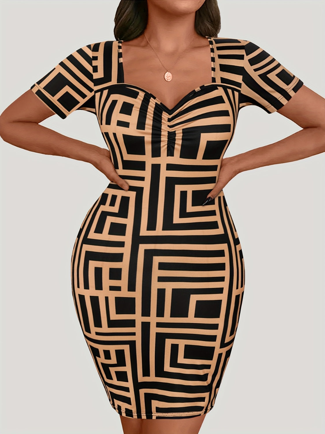 Plus size sweetheart neck mini dress with short sleeves and bold geometric print