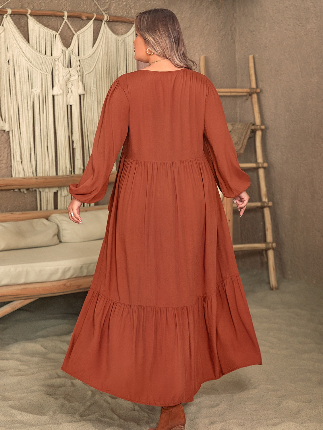 Trendsi plus size ruffled dress in burnt orange with long sleeves and tiered skirt shown from back