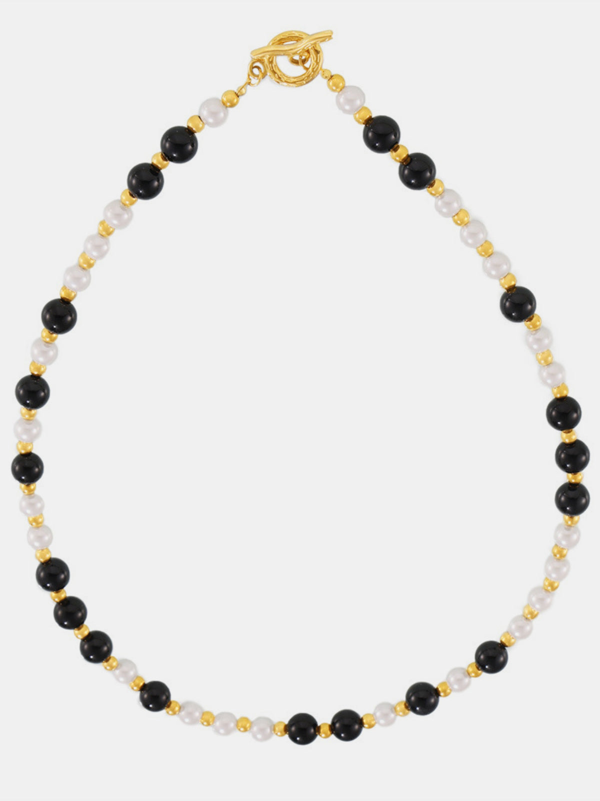 Stainless steel agate necklace featuring alternating black and white beads with gold accents and a toggle clasp