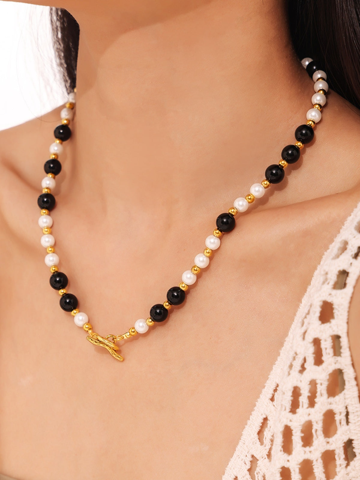 Trendsi stainless steel agate necklace with black and white beads worn on model's neck