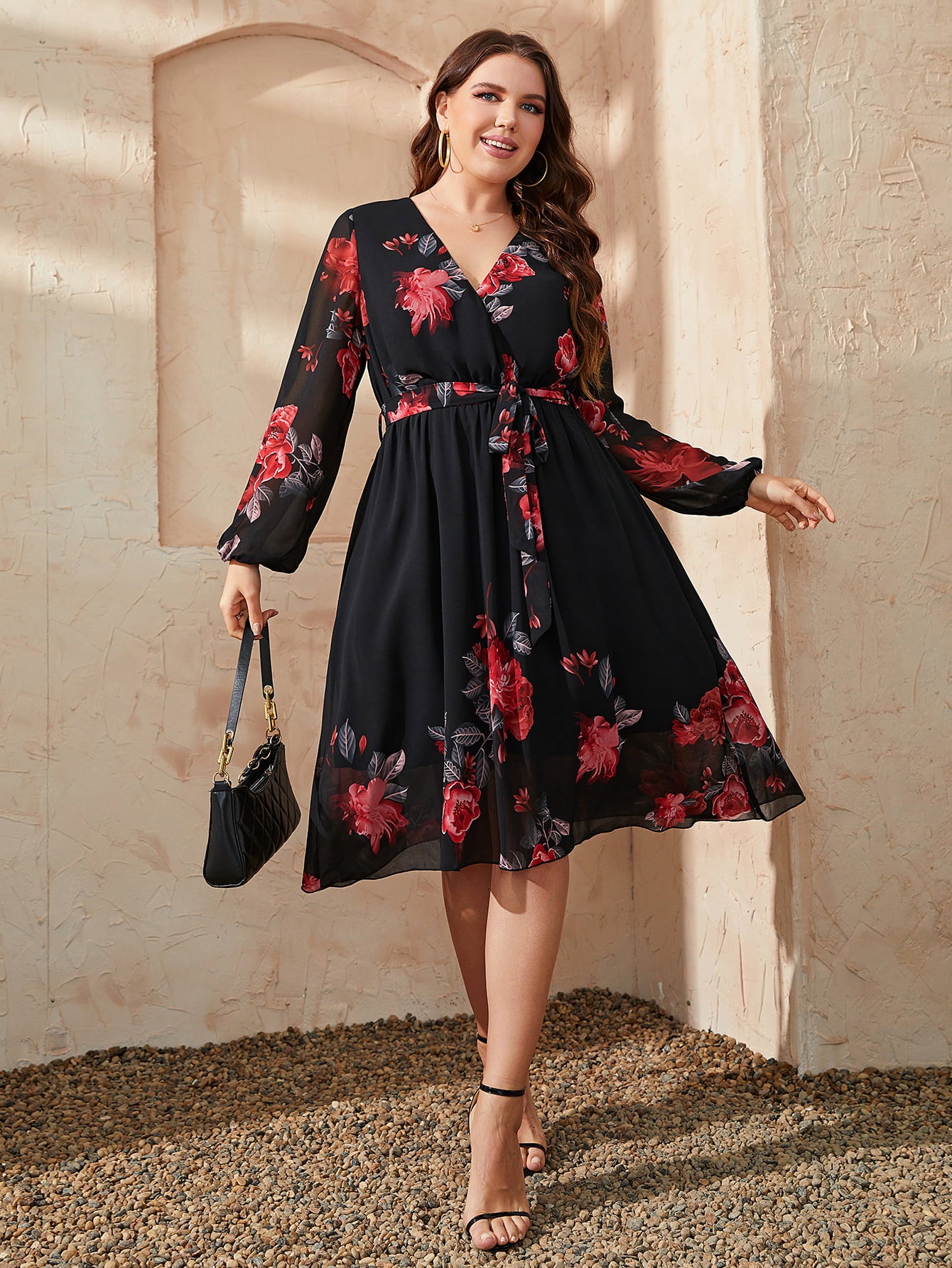 Trendsi plus size floral dress in black with red flower print and long sleeves styled with heels and handbag