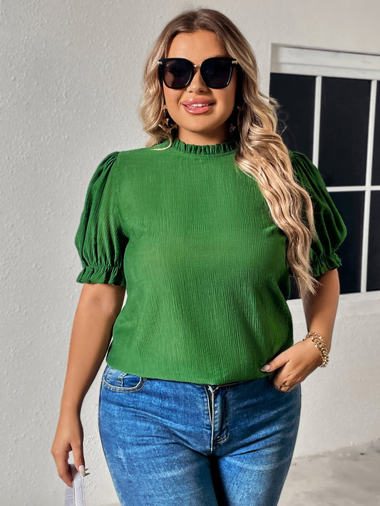 Green round neck plus size top for women with puff sleeves worn with blue jeans