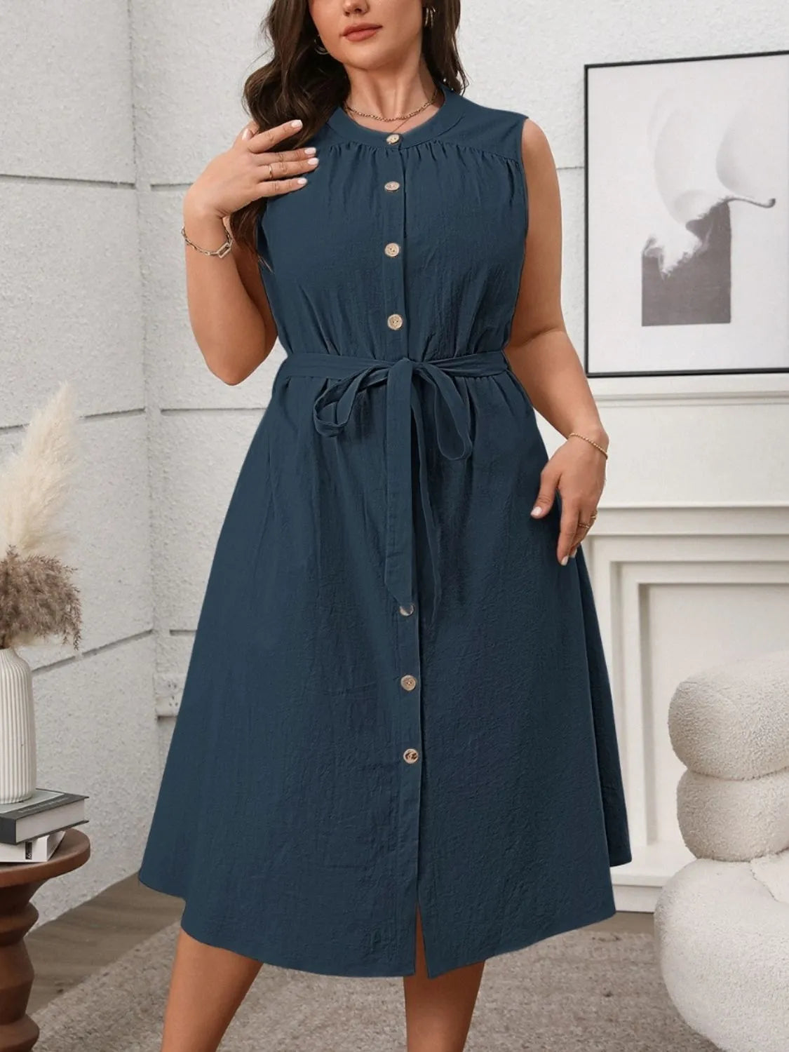  sleeveless tie waist plus size dress in navy blue with front buttons and a midi length